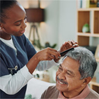 elderly man and nurse with comb for hair care
