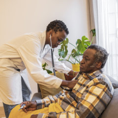 nurse monitoring bp on elder